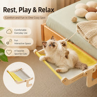 Ragdoll cat playing in a wooden bedside cat hammock with yellow fabric bed